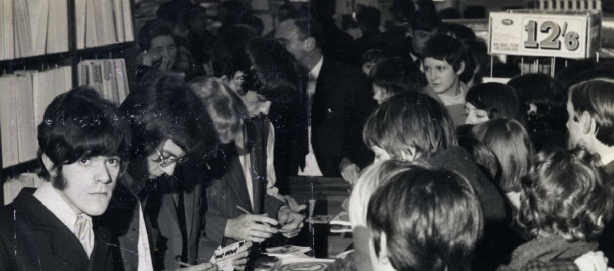 Black and wshite photograph of a busy 1960s record shop during signing by The Move